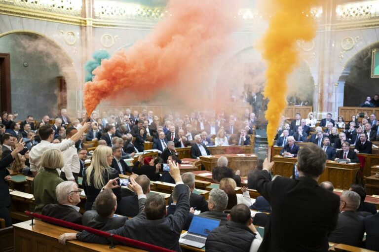 Hungarian Parliament bans Budapest Pride LGBTQ march as opposition protests with smoke bombs.